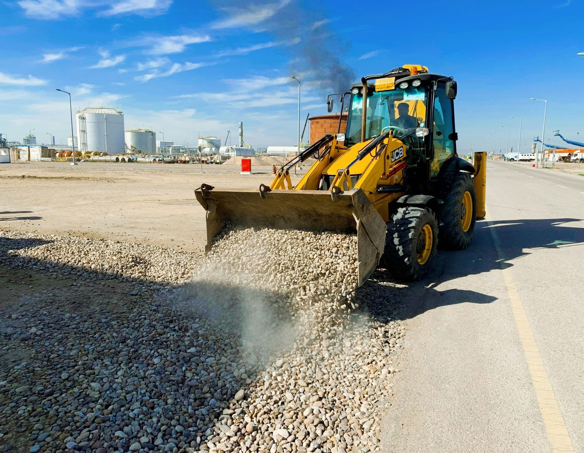 Loader placing and grading gravel
